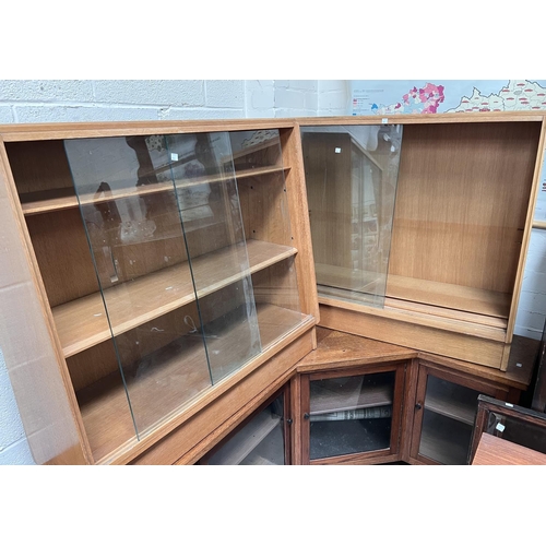 981 - A pair of mid 20th century G-plan lightwood bookcases with sliding doors