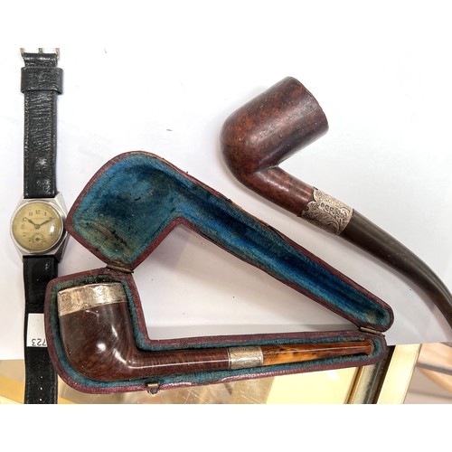 600B - A silver mounted pipe, amber mouthpiece, cased; another pipe; a 1930's gent's Dominant mechanical wa... 