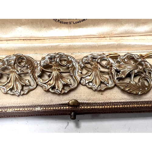 698C - An Art Nouveau set of gilt cased buttons, floral pierced decoration, in fitted cream lined presentat... 