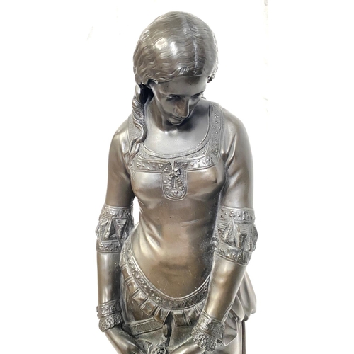 4 - A large bronzed resin figure of a young woman with purse, height 57cm