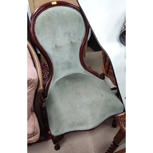 851 - A spoon back nursing chair with sage upholstery