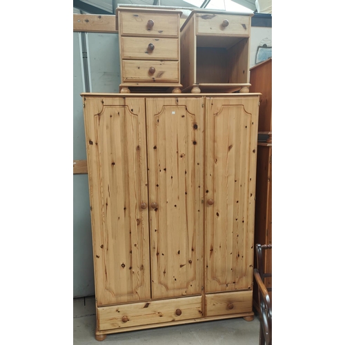 821 - A modern pine triple wardrobe, kneehole dressing table and pair of bedside cabinets