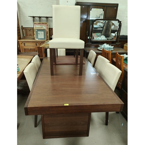 867 - An extending dining table by Bentley designs with a set of 8 chairs with high backs in cream leather... 