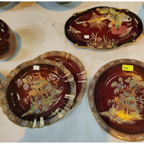 522 - Two Carlton Rouge Royale plates with chinoiserie decoration; a similar oval dish with spider's web