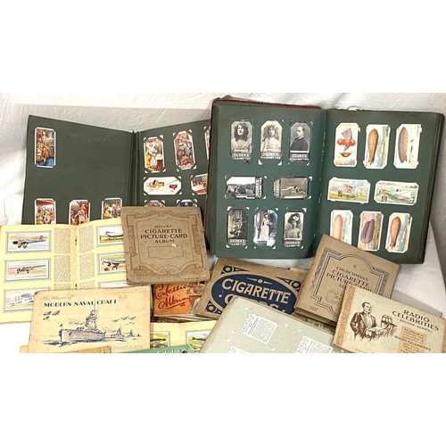 11 - A selection of cigarette cards in albums