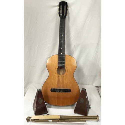 159 - Two metronomes; an acoustic guitar; a music stand