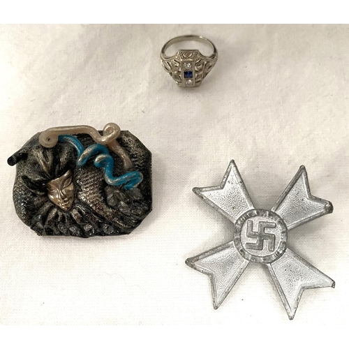 18 - A cased piece of the Berlin wall, a German WWII style badge, a Medusa brooch, a pair of gilt tea spo... 