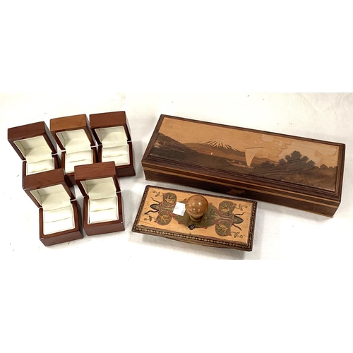 26 - An extensively inlaid desk blotter; an inlaid marquetry box depicting mount Fujiyama and various woo... 