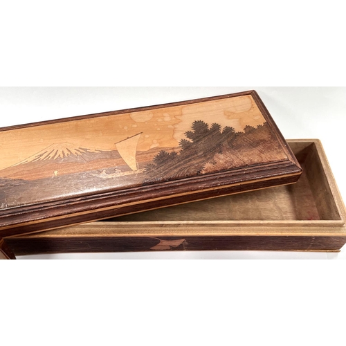 26 - An extensively inlaid desk blotter; an inlaid marquetry box depicting mount Fujiyama and various woo... 