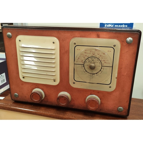 34A - A 1940's/1950's mahogany cased radio with red metallic tuners and plastic turning dial.