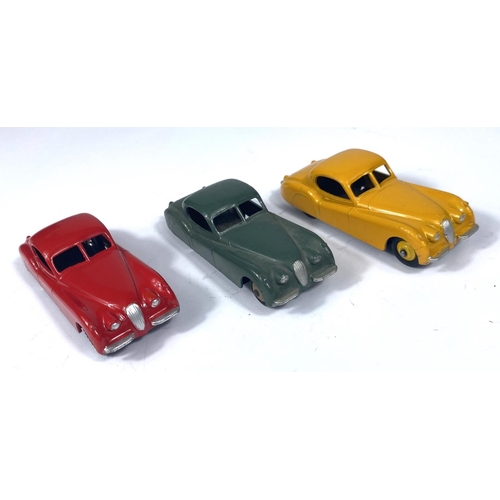 355 - DINKY TOYS: three 157 Jaguar XK120 in three different colours, yellow with yellow ridged hubcaps, re... 