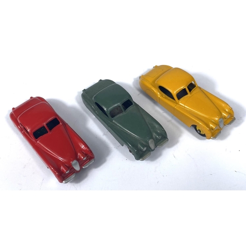 355 - DINKY TOYS: three 157 Jaguar XK120 in three different colours, yellow with yellow ridged hubcaps, re... 