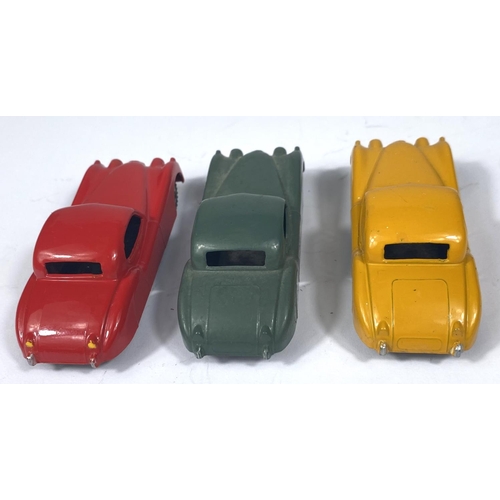 355 - DINKY TOYS: three 157 Jaguar XK120 in three different colours, yellow with yellow ridged hubcaps, re... 