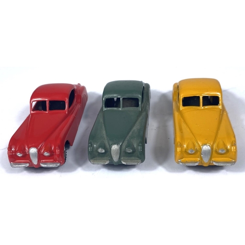 355 - DINKY TOYS: three 157 Jaguar XK120 in three different colours, yellow with yellow ridged hubcaps, re... 