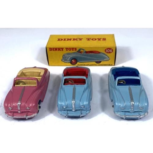 358 - DINKY TOYS: Three 106 Austin Atlantic Convertibles, pink with beige interior and hubcaps, two blue o... 