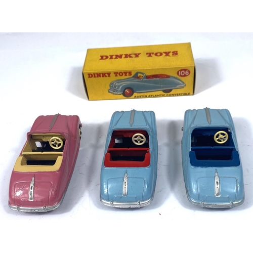 358 - DINKY TOYS: Three 106 Austin Atlantic Convertibles, pink with beige interior and hubcaps, two blue o... 