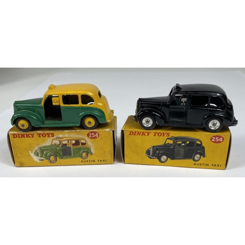 389 - DINKY TOYS: Two 254 Austin Taxi's one in black and one in two tone green and yellow colourways, one ... 