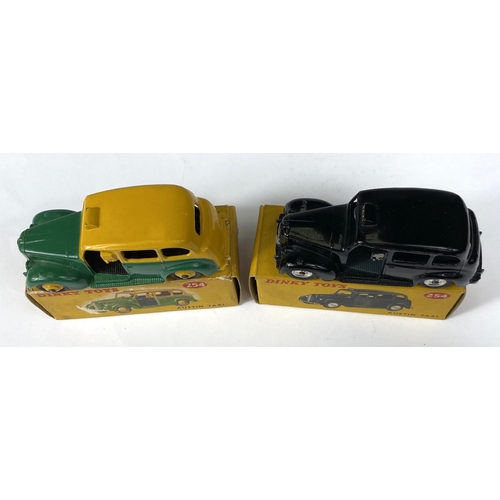 389 - DINKY TOYS: Two 254 Austin Taxi's one in black and one in two tone green and yellow colourways, one ... 