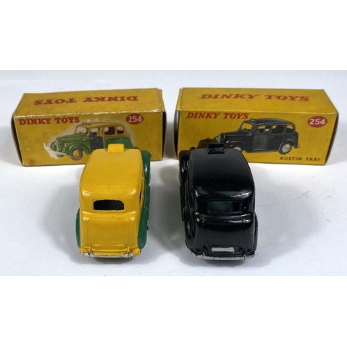 389 - DINKY TOYS: Two 254 Austin Taxi's one in black and one in two tone green and yellow colourways, one ... 