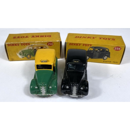 389 - DINKY TOYS: Two 254 Austin Taxi's one in black and one in two tone green and yellow colourways, one ... 