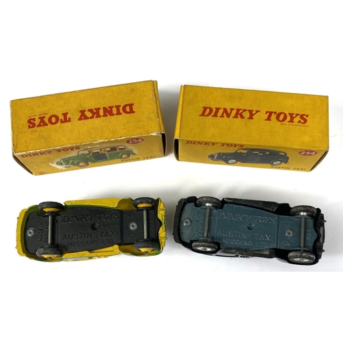 389 - DINKY TOYS: Two 254 Austin Taxi's one in black and one in two tone green and yellow colourways, one ... 