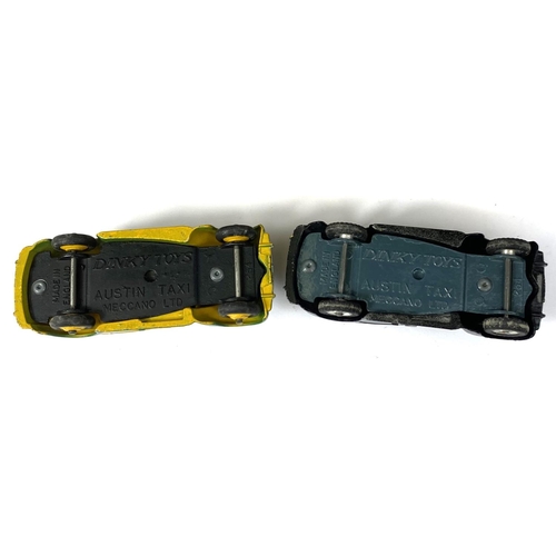 389 - DINKY TOYS: Two 254 Austin Taxi's one in black and one in two tone green and yellow colourways, one ... 