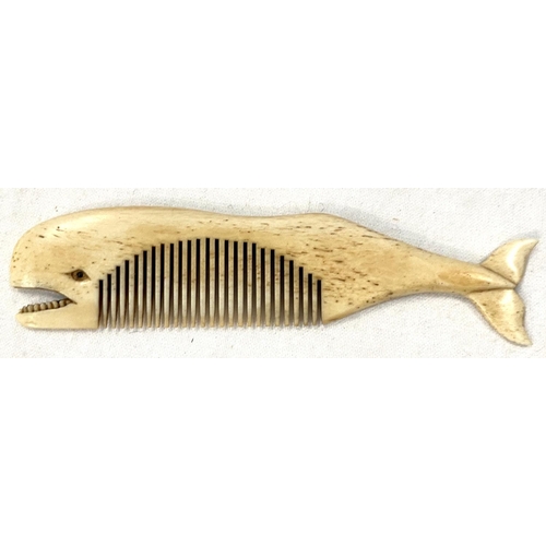 42 - A scrimshaw whalebone comb carved in the form of a whale, length 11cm