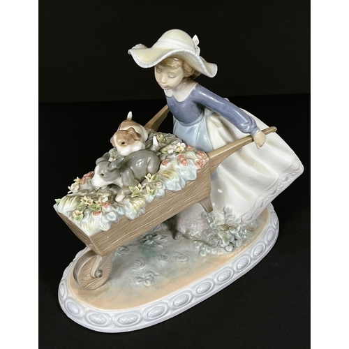 503 - A Lladro 'Barrow of Fun' figure - girl pushing a wheelbarrow with 2 puppies, length 23cm (a couple o... 