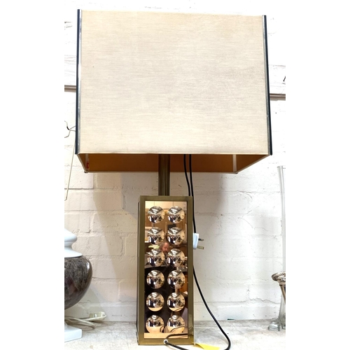54 - A modernist table lamp in gilt metal with dimpled mirror glass