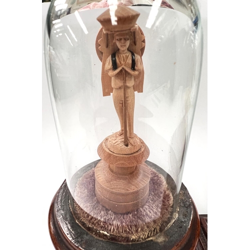 62 - A 19th century pair of miniature carved figures under glass domes on stepped square bases