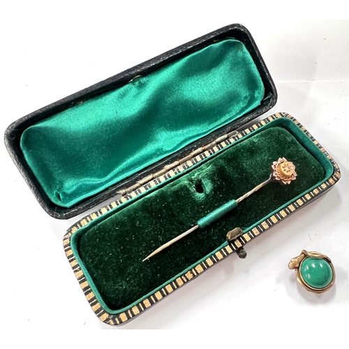 662 - A Victorian diamond set stick pin; a yellow metal stud set with a green stone.