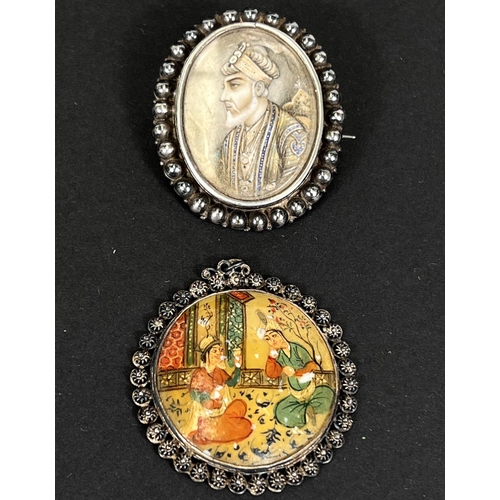 663 - A brooch set with a 1/2 length portrait of a person potentate with a beard; a mother of pearl set br... 