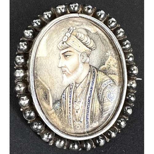 663 - A brooch set with a 1/2 length portrait of a person potentate with a beard; a mother of pearl set br... 