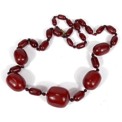 701A - A string of amber Bakelite coloured beads, 80g.