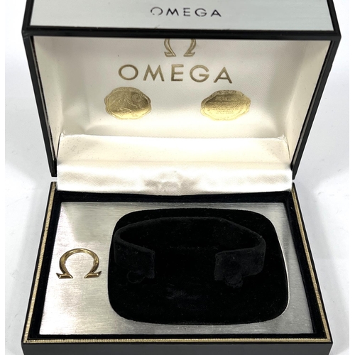 703 - An Omega, brushed aluminium finish watch box. 13 x 10cm