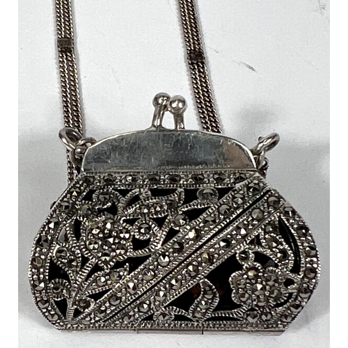 719 - A hallmarked silver novelty marcasite pendant in the form of a purse with triple strand silver chain... 