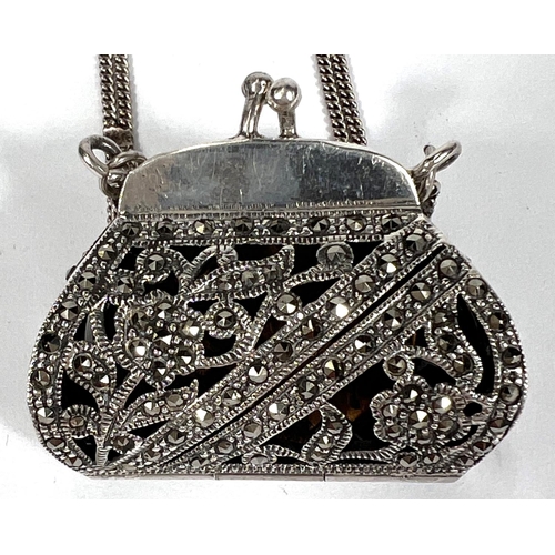 719 - A hallmarked silver novelty marcasite pendant in the form of a purse with triple strand silver chain... 