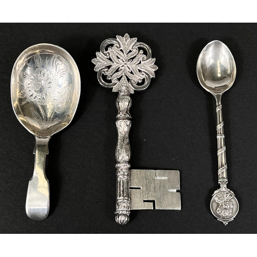 735 - A silver Victorian caddy spoon, a 1935 GV commemorative silver spoon and a silver key