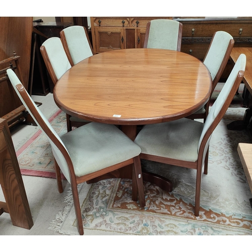 804 - A mid 20th century teak G-Plan oval extending dining table 'Whale Tale' supports six high back G-pla... 