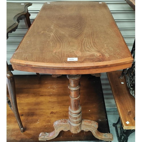 835 - An early 20th century mahogany table with turned legs and supports; a rattan footstool and a black b... 