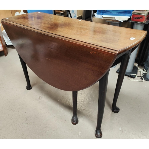 839 - A mid 18th century mahogany dining table with oval drop leaf top, on pad feet, length 128cm