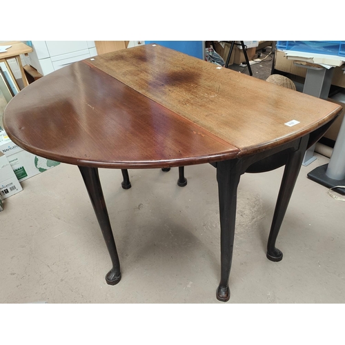 839 - A mid 18th century mahogany dining table with oval drop leaf top, on pad feet, length 128cm