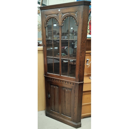 850 - A good quality oak full height corner cupboard with panelled door bellow and glazed door above; An E... 