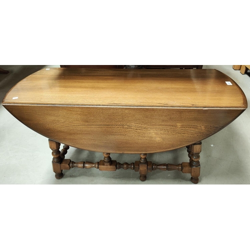 871 - An Ercol light wood coffee table with drop sides, bobbin turned legs, length 104cm