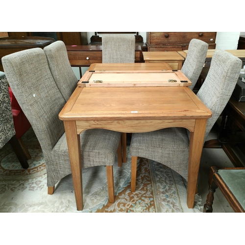 894 - A light oak extending dining table, rectangular form with 6 modern dining chairs in fawn upholstery ... 