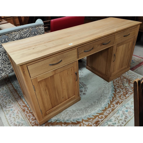 895 - A large modern light oak desk, two large cupboards to each pillar and three frieze drawers, length 1... 