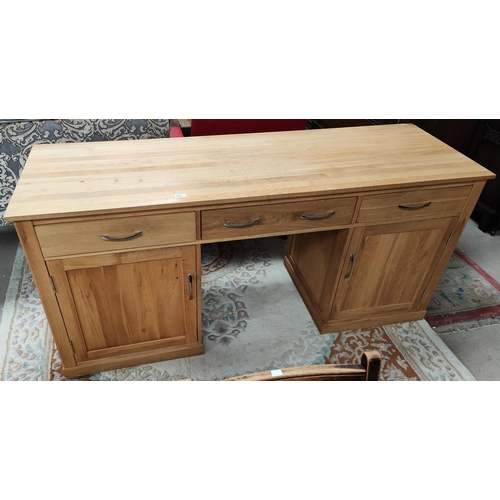 895 - A large modern light oak desk, two large cupboards to each pillar and three frieze drawers, length 1... 