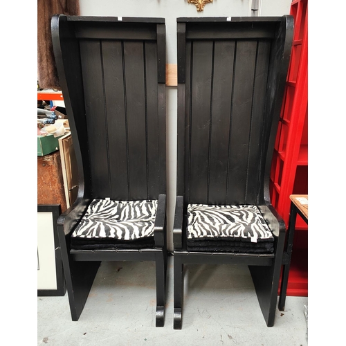 911 - A pair of unusual high back chairs in black finish