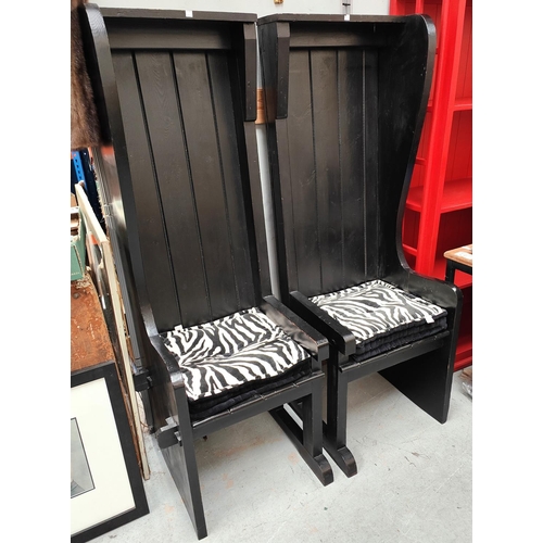 911 - A pair of unusual high back chairs in black finish