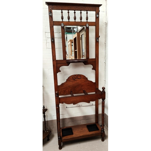 914 - An Edwardian stained walnut hall stand with mirror back